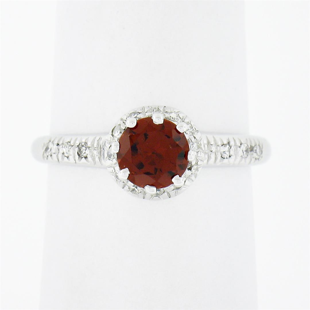 Vintage 18k White Gold.93 ctw Round Prong Garnet Solitaire & Diamond Accents Rin: A vintage solid 18k white gold ring, with 1 round cut natural garnet (5.65mm - 0.75ct (), accented with 18 old single cut natural diamonds (G/H - VS1/VS2 ; 0.18ct). The ring is size 6.5, weighs a tota