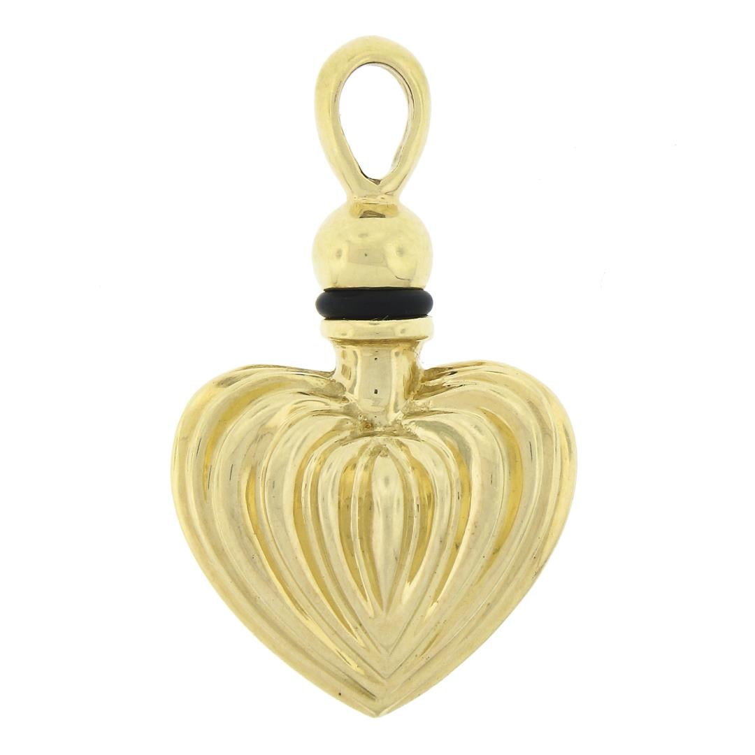 LAGOS 18K Yellow Gold Fluted Puffed Heart Perfume Flask Bottle Charm Pendant: A solid 18k yellow gold bottle pendant by Lagos. The pendant weighs a total of 18.69 grams, measures 35.4x21.3mm including the bail, and the inside of the bail measures 5.8x3.6mm.