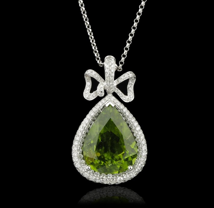 18KT White Gold 15.72ct Peridot and Diamond Necklace FJ: 18KT White Gold 15.72ct Peridot and Diamond Necklace FJM2378. Excellent Condition! OR9213RM. One lady’s polished, stamped and electronically tested solid 18K white gold pendant mounted with: 1 Genui