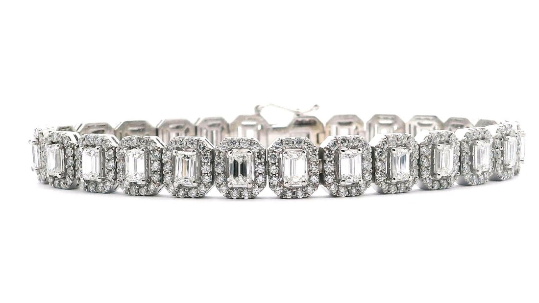 11.15 ct. Diamond Tennis Bracelet - 14KT White Gold: This bracelet features 25 emerald cut diamonds totaling 6.15ct with VS-1 to VS-2 clarity and G-H color, surrounded by 350 round brilliant diamonds totaling 5.00ct. A stunning tennis bracelet design! O