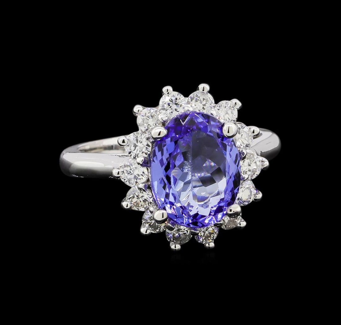 3.45 ctw Tanzanite and Diamond Ring - 14KT White Gold: One electronically tested 14KT white gold lady's cast fashion ring with a cathedral basket halo with a bright polish finish. The featured lady's ring has a shank measuring 2.33 millimeters in width. I