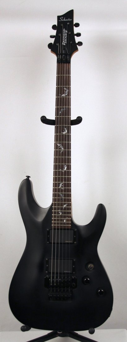 Schecter Damien FR in Flat Black DGUI39: Schecter Damien FR in Flat Black DGUI39. Good Condition! DG771FP. The Schecter Damien FR is a true rock electric guitar that features an arched basswood body, bolt-on rock maple neck, and a rosewood f