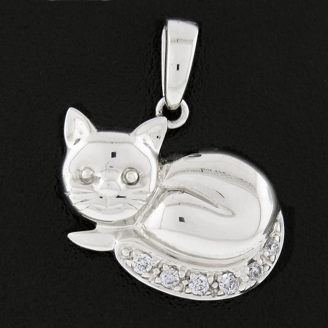 14K White Gold Cat Kitten w/ 0.05 ctw Pave Diamond Tail Collectible Charm Pendan: A solid 14k white gold cat pendant, with 6 round brilliant cut natural diamonds (G/H - VS1/VS2 ; 0.05ctw). The pendant weighs a total of 1.61 grams, measures 17.20x14.30mm including the bail, and the 