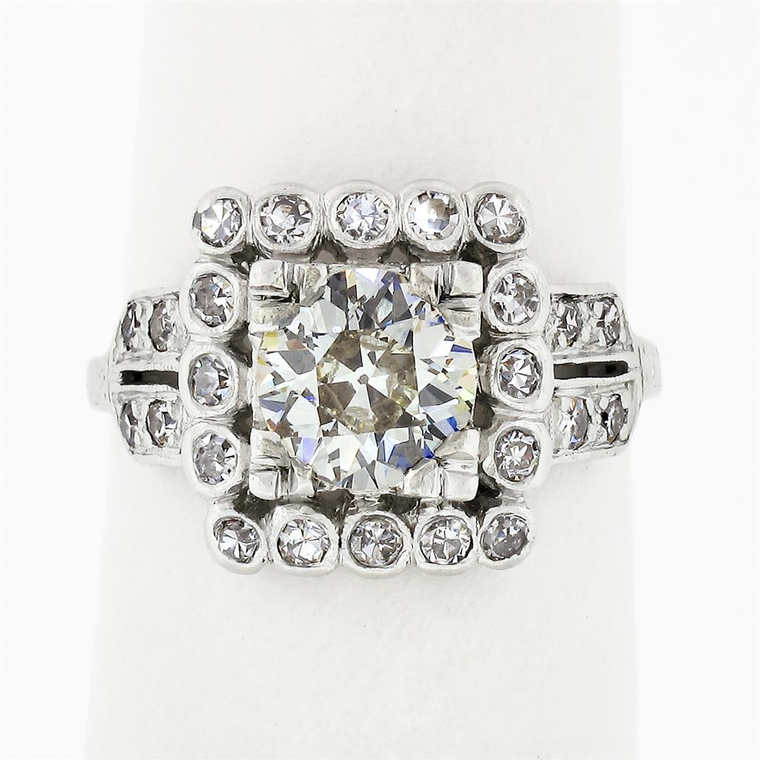 Antique Art Deco Platinum 1.74 ctw Euro Diamond Solitaire & Halo Engagement Ring: An antique art deco solid platinum engagement ring, featuring 1 old european cut natural diamond (O/P - VS2 ; 6.75mm - 1.20ct), surrounded with 24 round single cut natural diamonds (G/H - VS1 to SI1 ;