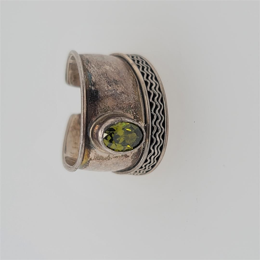 Sterling Silver Ring: One Sterling Silver Ring. The ring size is adjustable. Contains semiprecious stones.