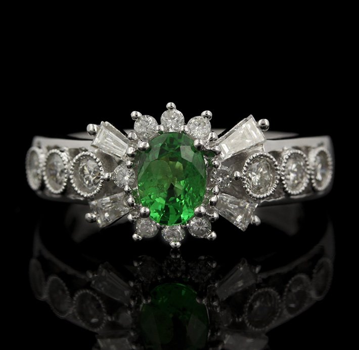 18KT White Gold 0.62ct Tsavorite and Diamond Ring FJM22: 18KT White Gold 0.62ct Tsavorite and Diamond Ring FJM2268. Excellent Condition! ZD997CU. One ring featuring: 4.40gm of 18KT white gold, (1) tsavorite with a total weight of 0.62cts and (18) baguette a