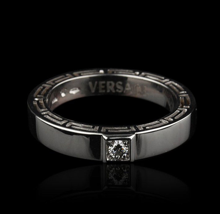 Gents Versace 18KT White Gold Diamond Ring GB656: Gents Versace 18KT White Gold Diamond Ring GB656. Good Condition! ZX928SW. One gents Versace 18KT white gold diamond ring. The ring features: 18KT white gold, single round cut diamond, stylized edge a