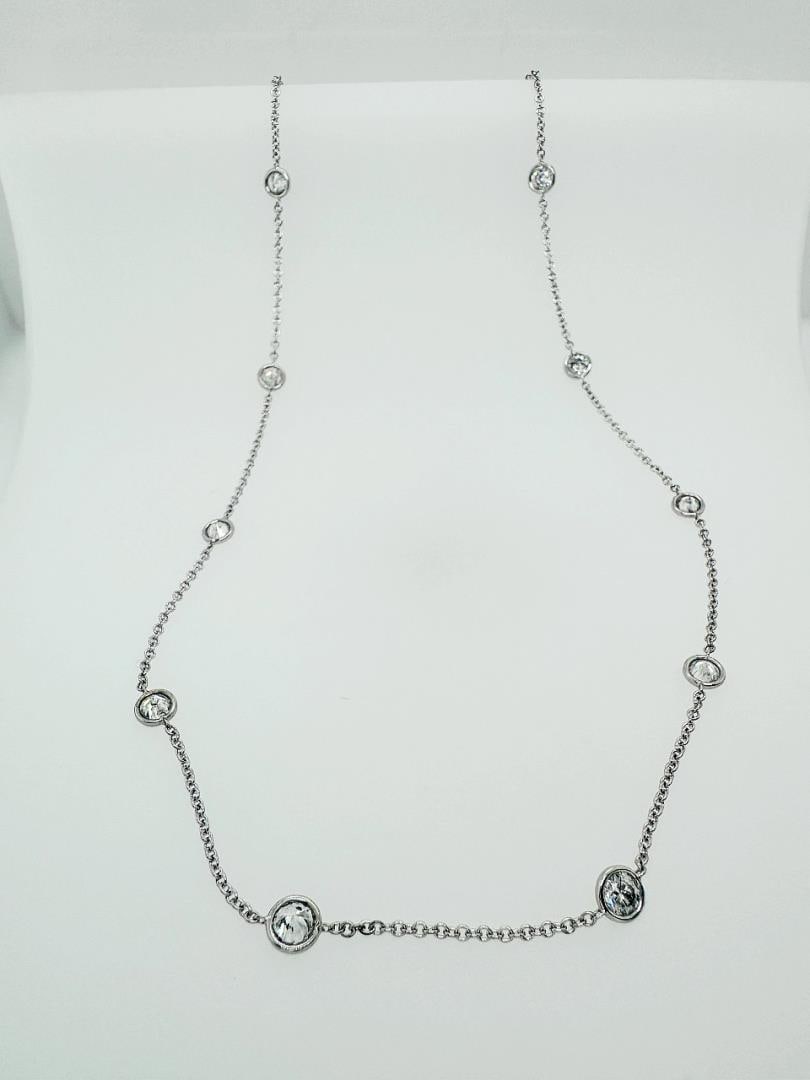 2.99 ctw "Diamonds by the Yard" Diamond Necklace - 18K White Gold: This stunning 2.99 carat total weight "Diamonds by the Yard" necklace features round brilliant-cut diamonds, elegantly set along a delicate 18K white gold chain. Each diamond is bezel-set, allowing li