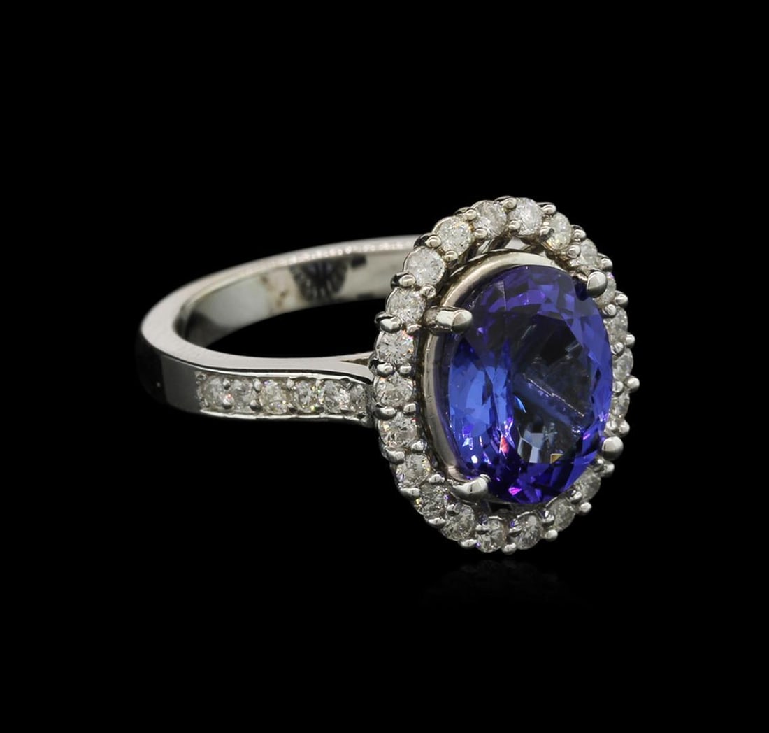 3.73 ctw Tanzanite and Diamond Ring - 14KT White Gold: One electronically tested 14KT white gold lady's cast fashion ring with a halo with a bright polish finish. The featured lady's ring has a shank measuring 2.78 millimeters wide. Identified with markin