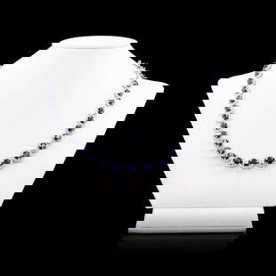 34.28 ctw Blue Sapphire and 7.39 ctw Diamond 14K White Gold Necklace: Fourteen karat (14K) white gold natural sapphire corundum and diamond necklace. Oval brilliant cut natural sapphire corundum gemstones are mounted in the center of the necklace. Round brilliant cut di