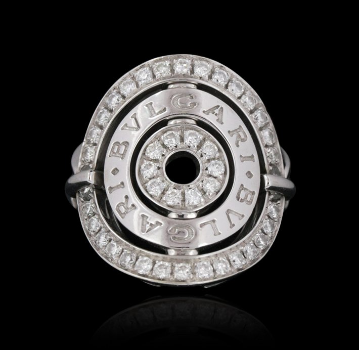 18KT White Gold Bulgari Designer Diamond Ring GB1465: 18KT White Gold Bulgari Designer Diamond Ring GB1465. Great condition! TC9022VP. One Bulgari designer ring featuring: 10.5 grams of 18KT white gold and diamonds. Thank you for viewing this lot! We are