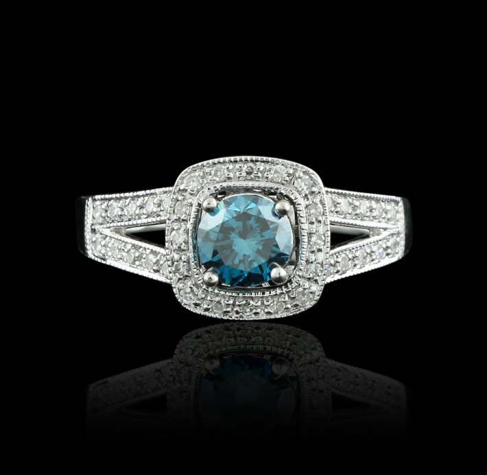 18KT White Gold 0.70ct Blue Diamond & White Diamond Rin: 18KT White Gold 0.70ct Blue Diamond & White Diamond Ring GB1432. Good condition! FQ7501TH. One electronically tested 18KT white gold ladies cast & assembled diamond ring. Condition is good. The featur