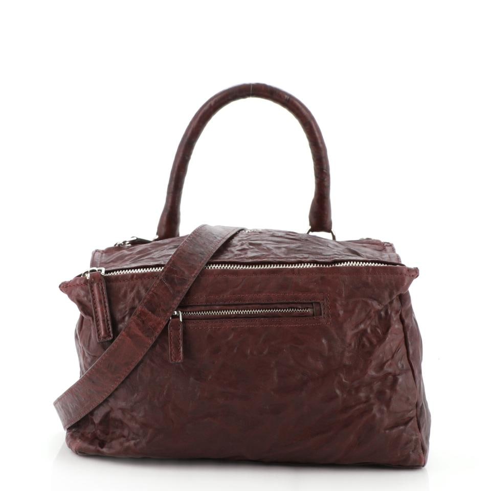 Givenchy Pandora Distressed Shoulder Bag in Burgundy: One Givenchy Pandora Distressed Shoulder Bag in Burgundy. Single strap, black canvas CLEAN interior. No smoke or perfume smells. Zip Closure at front w/gold tone hardware. Slight wear and discoloratio
