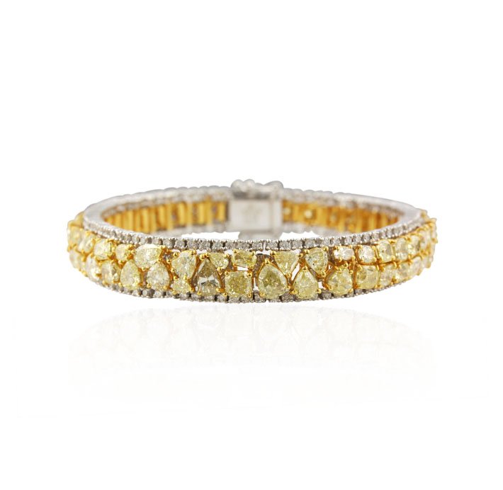18KT Yellow & White Gold 20.79ctw Fancy Yellow Diamond : 18KT Yellow & White Gold 20.79ctw Fancy Yellow Diamond Bracelet A4613. Excellent Condition! YJ93521WG. One electronically tested 18KT two-tone, yellow & white gold ladies cast & assembled diamond brac