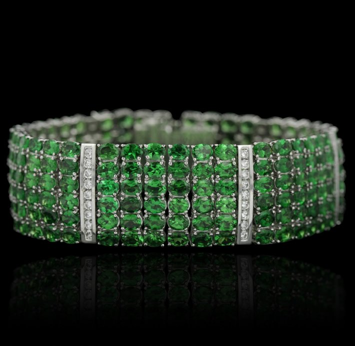 18KT White Gold 110.00ctw Green Tsavorite and Diamond B: 18KT White Gold 110.00ctw Green Tsavorite and Diamond Bracelet GB1539. Great condition! LU9429PX. One bracelet featuring: 59.1 grams of 18KT white gold, green tsavorite with a total weight of 110.00ct