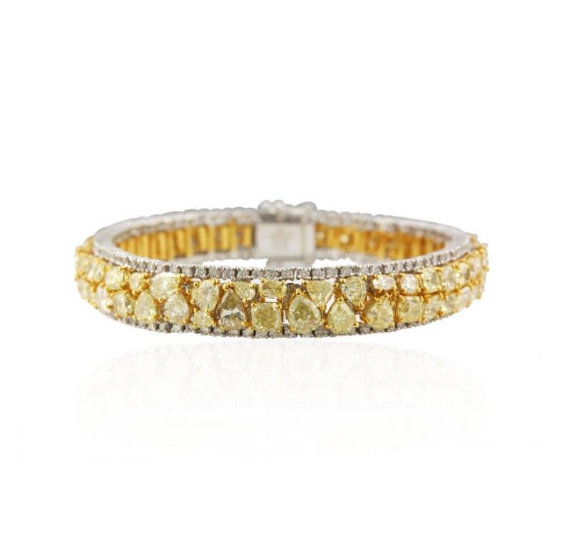 18KT Yellow & White Gold 20.79ctw Fancy Yellow Diamond: 18KT Yellow & White Gold 20.79ctw Fancy Yellow Diamond Bracelet A4613. Excellent Condition! ZD60041ZV. One electronically tested 18KT two-tone, yellow & white gold ladies cast & assembled diamond brac