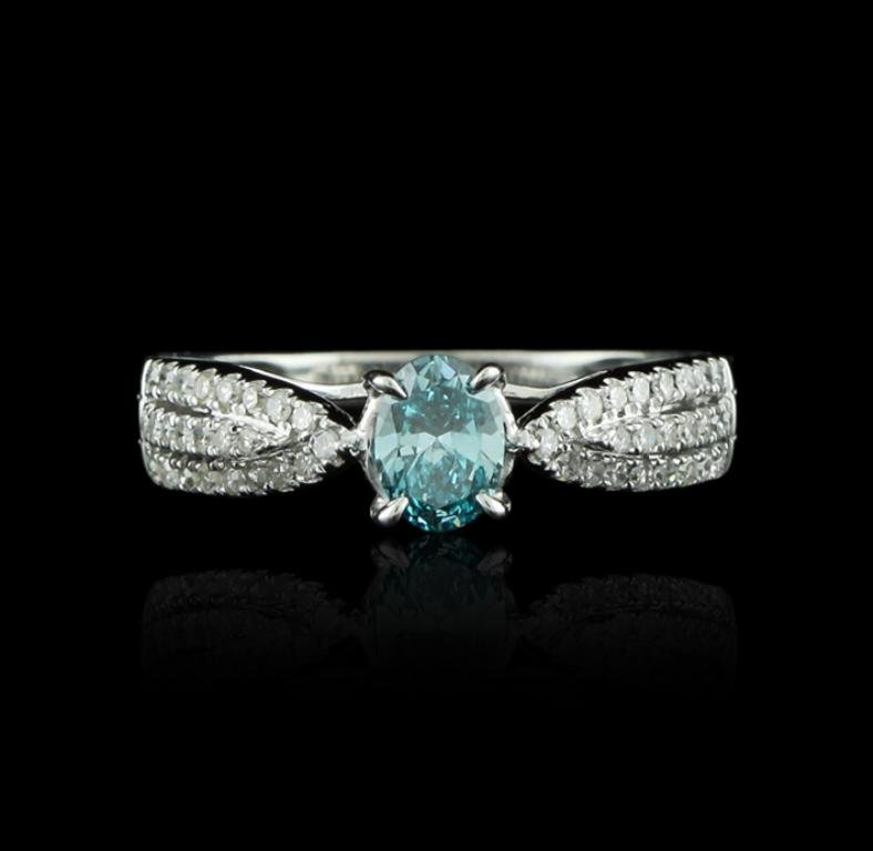 18KT White Gold 0.44ct Blue Diamond and White Diamond: 18KT White Gold 0.44ct Blue Diamond and White Diamond Ring GB1446. Good condition! NM208CP. One ring featuring: 2.6 grams of 18KT white gold, (1) blue diamond with a total weight of 0.44ct and diamond