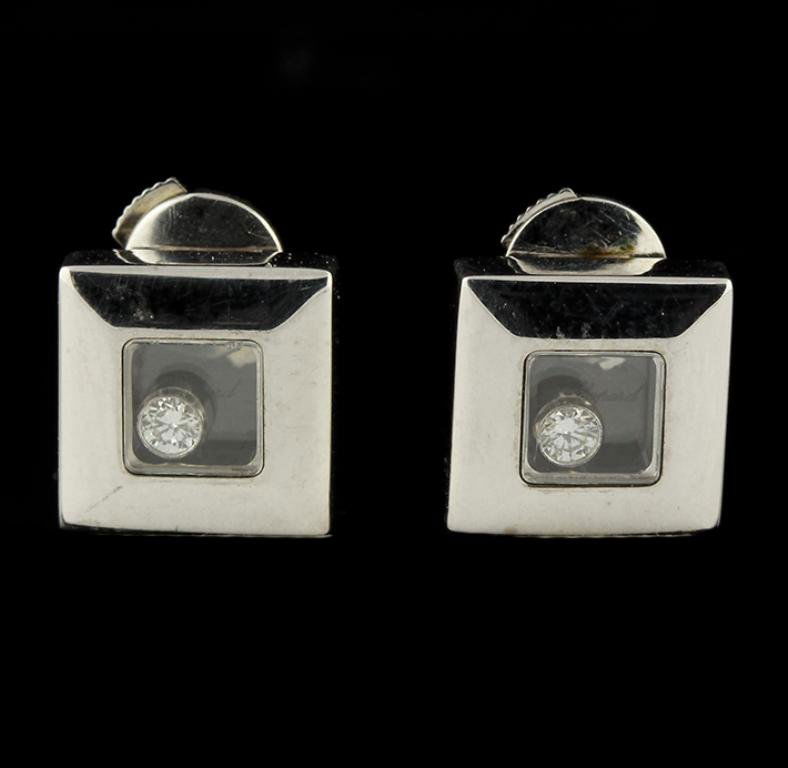 18KT White Gold 0.10ctw Diamond Chopard Earrings GB1932: 18KT White Gold 0.10ctw Diamond Chopard Earrings GB1932. Good Condition! MN1061SV. One pair of Chopard earrings featuring: 9.2 grams of 18KT white gold and diamonds with a total weight of 0.10ctw.
