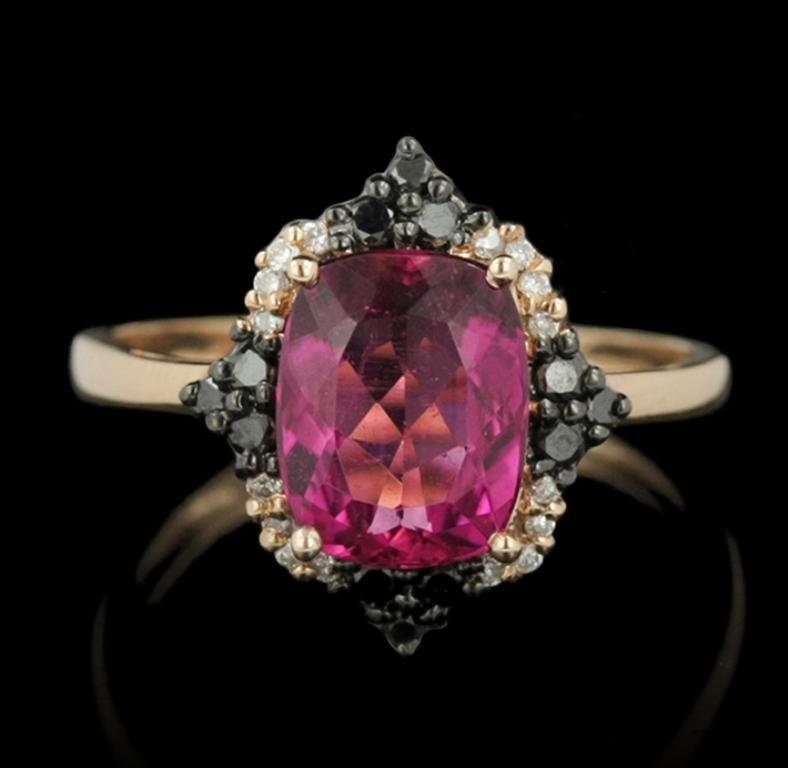 14KT Rose Gold 1.87ct Rubelite & Diamond Ring CRJ29: 14KT Rose Gold 1.87ct Rubelite & Diamond Ring CRJ29. Good Condition! PG106YG. One ring featuring: 1.94 grams of 14KT rose gold. (1) Rubelite with a total weight of 1.87ct. (12) diamonds with a total w