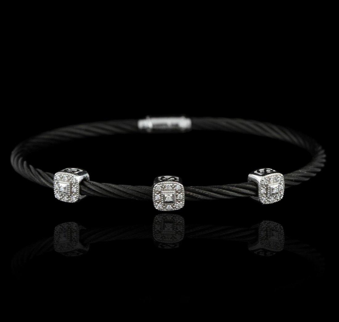 18KT White Gold Charriol 0.25ctw Diamond Black S/S Rope: 18KT White Gold Charriol 0.25ctw Diamond Black S/S Rope Bracelet GB2597. Good Condition. NA155VJ. One charriol bangle bracelet featuring 9.4 grams of 18KT white gold, black and stainless steel rope, a