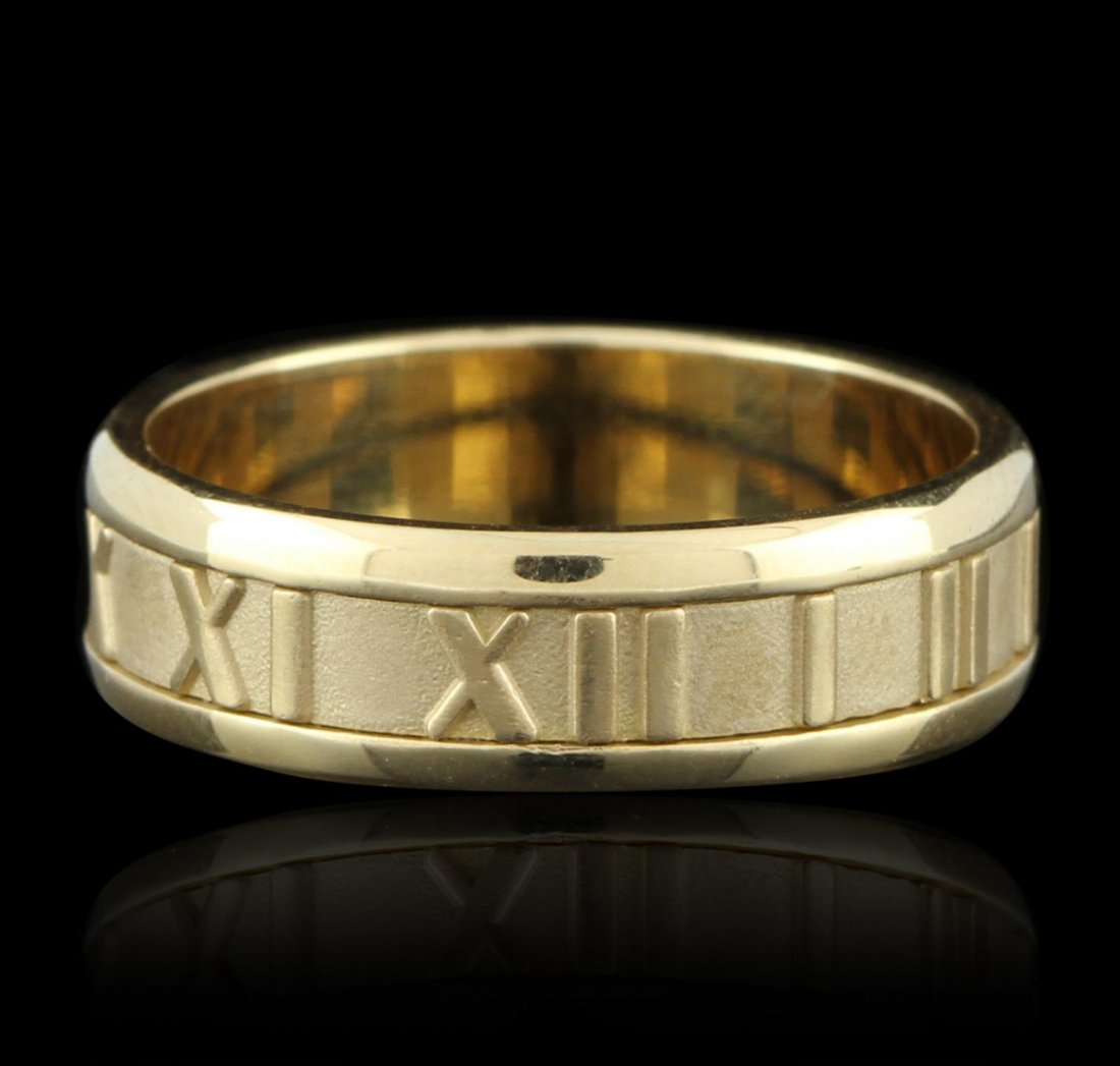 Tiffany & Co. 18KT Yellow Gold Roman Numeral Band Ring: Tiffany & Co. 18KT Yellow Gold Roman Numeral Band Ring GB2665. Good Condition! NW406LU. One tiffany and Co. ring featuring: 10.1 grams of 18KT yellow gold and roman numerals wrapped around the outside