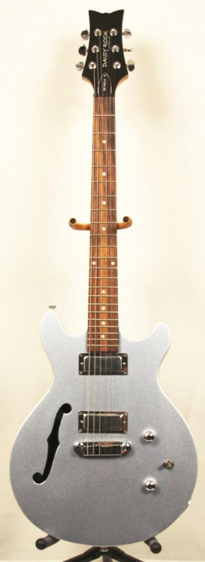 Daisy Rock Retro H Hollow Body GUI36: Daisy Rock Retro H Hollow Body GUI36. New Condition! HM653EM. Daisy Rock Retro H Hollow Body. Store demo with 2 noiseless hum bucking pickups in purple.
