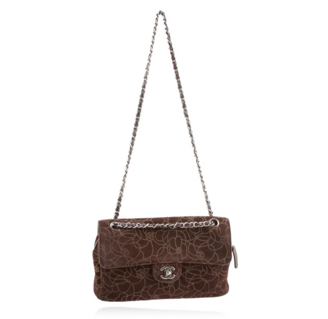 Chanel Brown Suede Maxi Flap Bag LB28: Chanel Brown Suede Maxi Flap Bag LB28. Good Condition! TD7052UX. One Chanel maxi flap bag featuring: brown suede, flower print and measures 11.5" x 2.5" x 7". There is a small rip on the inside of the