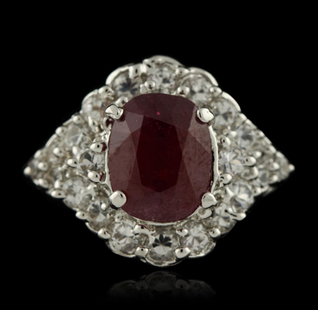 SILVER 3.70ct Mixed Ruby and White Topaz Ring SLV332: SILVER 3.70ct Mixed Ruby and White Topaz Ring SLV332. Good Condition! JJ502UJ. One ring featuring: 5.26 grams of sterling silver and (1) oval mixed ruby measuring: 10.00 x 7.80 x 5.30, carat weight 3.