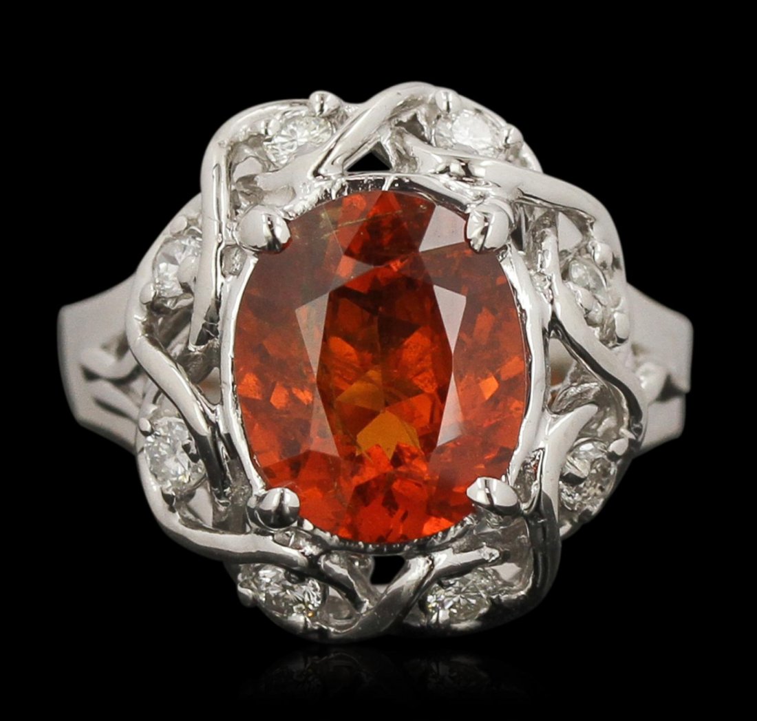 14KT White Gold 3.43ct Garnet and Diamond Ring DJ124: 14KT White Gold 3.43ct Garnet and Diamond Ring DJ124. Good Condition! PB5573JJ. One 14KT White Gold ring with a weight of 6.15 grams including: Center oval shape natural Mandarin Spessartite Garnet wi