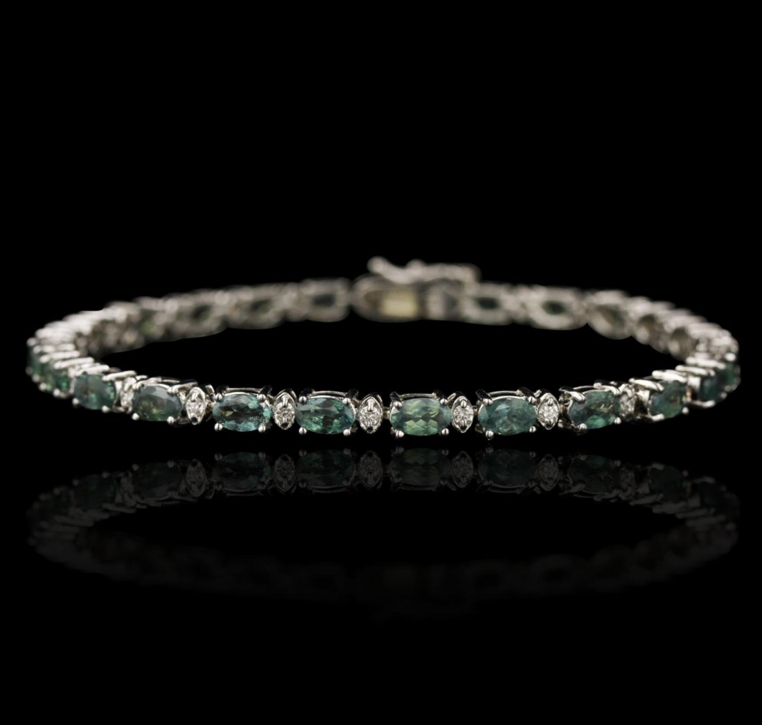 14KT White Gold 6.60ctw Alexandrite and Diamond: 14KT White Gold 6.60ctw Alexandrite and Diamond Bracelet DJ99. Good Condition! VZ4053FE. One 14KT white gold bracelet weighing 8.69 grams, featuring 6.60 carats of oval shape natural alexandrite with