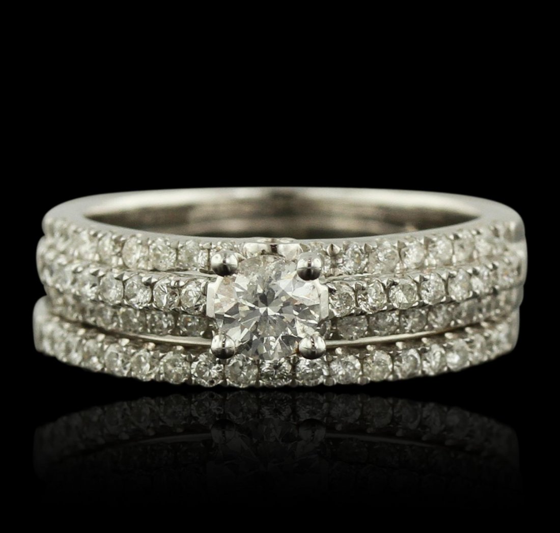 14KT White Gold 1.07ctw Diamond Ring Wedding Set: 14KT White Gold 1.07ctw Diamond Ring Wedding Set FJM3562. Good Condition! UR408HM. One ring featuring: 14KT White Gold with a total weight of 6.20 grams, (1) Diamond with a total weight of 0.33ctw, an