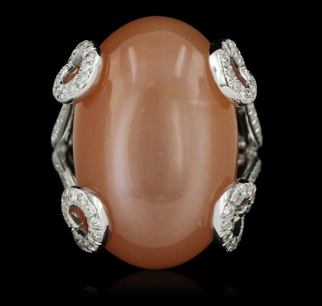 18KT White Gold 27.92ct Moonstone and Diamond Ring: 18KT White Gold 27.92ct Moonstone and Diamond Ring A8254. New Condition! UN3102PW. One electronically tested 18KT white gold lady's combination cast & assembled fashion ring with a bright polish finis