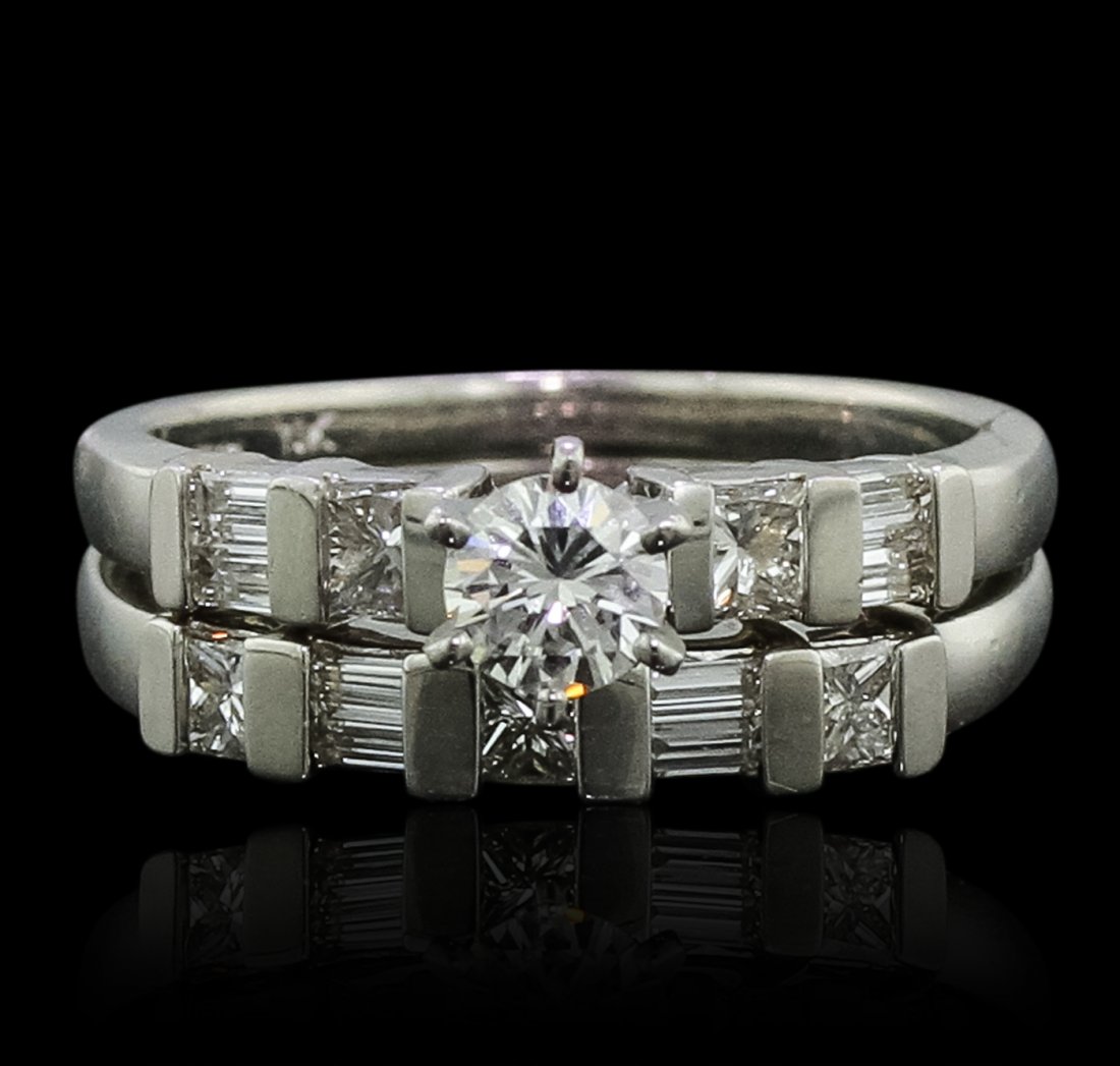 Platinum 1.22ctw Diamond Ring Wedding Set: One electronically tested platinum Ladies cast engagement ring & wedding band with a bright polish finish. Condition is new. Identified with markings of "PT 900". Containing: One prong set round brill