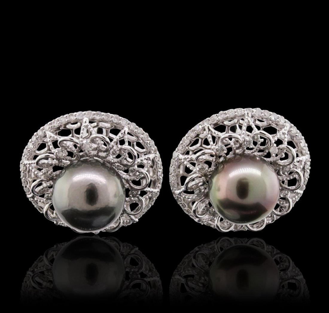 14KT White Gold Pearl and Diamond Earrings: One pair electronically tested 14KT white gold Ladies earrings with Omega clip backs with a bright polish finish. Condition is new. Containing: Two Tahitian pearls, 10.6mm in size to 10.6mm in size. T