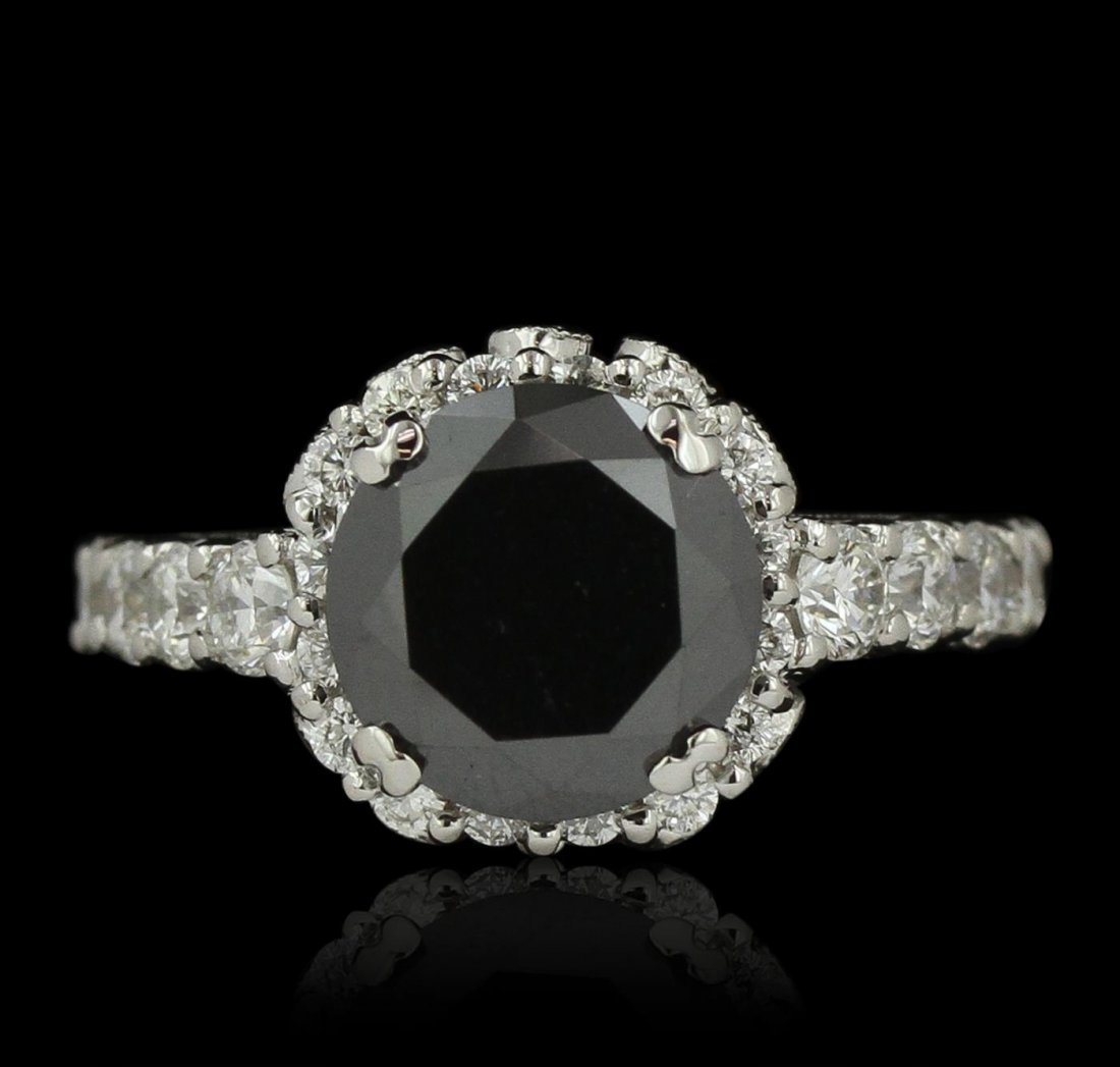 18KT White Gold 5.49ctw Black Diamond Ring: One electronically tested 18KT white gold ladies cast black and white diamond ring. Condition is new, good workmanship. The featured black diamond is set within a tiered white diamond bezel supported