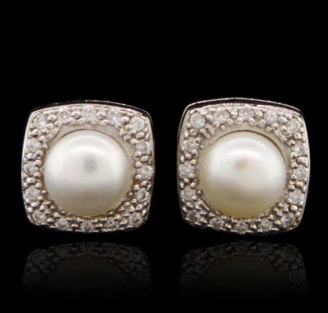 Charriol 18KT White Gold Pearl and Diamond Earrings: One pair of earrings featuring: 46.80 grams of 18KT white gold, (1) pearl and 0.16cts of diamonds.