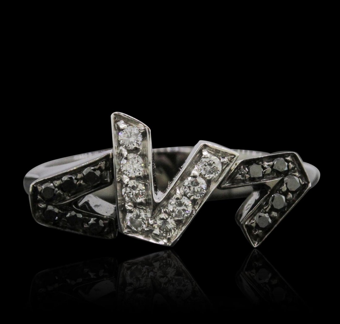 18KT White Gold 0.25ctw Diamond Versace Ring: One versace ring featuring: 18KT white gold weighing 7.3 grams containing 9 brilliant cut diamonds and 11 black diamonds for a total weight of 0.25cts. Shank engraved with VERSACE on either side. .