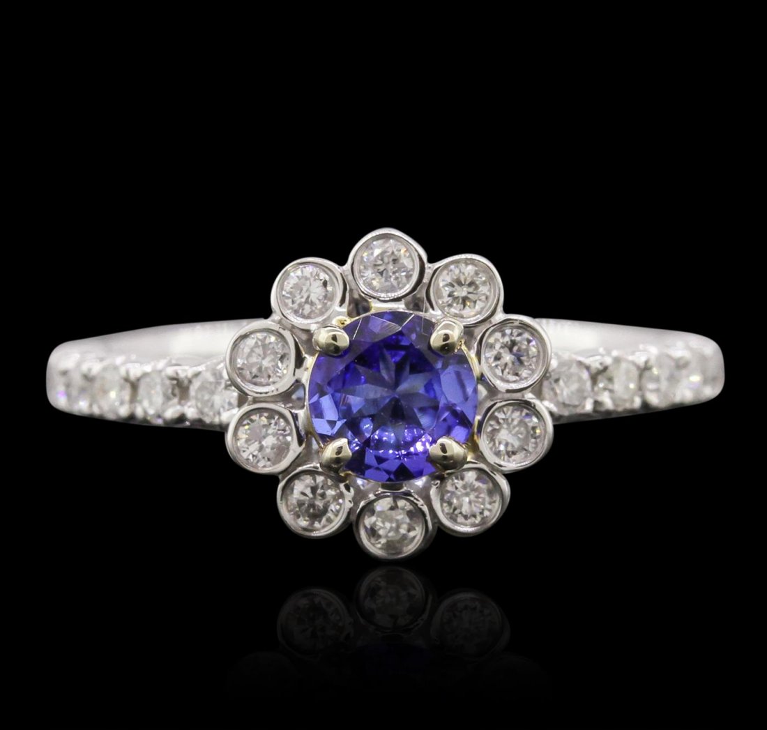 14KT White Gold 0.54ct Tanzanite and Diamond Ring: One electronically tested 14KT white gold ladies cast tanzanite and diamond ring with a bright polish finish. Condition is new, good workmanship. The featured tanzanite is set within a diamond floral 