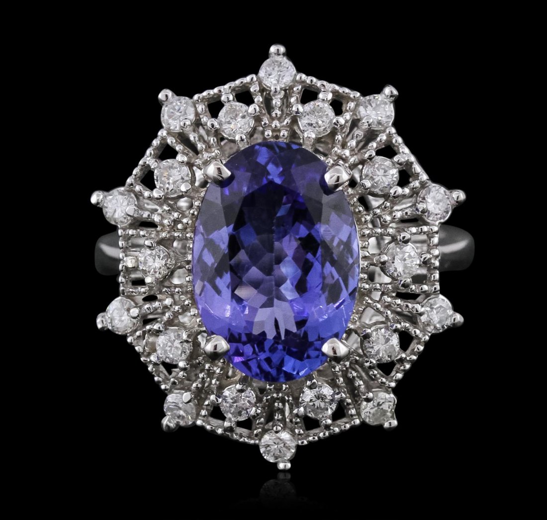 14KT White Gold 5.47ct Tanzanite and Diamond Ring: One electronically tested 14KT white gold ladies combination cast & assembled ring with a bright polish finish. Condition is new. Identified with markings of "K14". Containing: One prong set oval modi