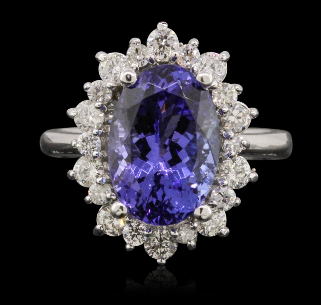 14KT White Gold 4.78ct Tanzanite and Diamond Ring: One electronically tested 14KT white gold ladies cast tanzanite and diamond ring with a bright polish finish. Condition is new, good workmanship. The featured tanzanite is set within a diamond bezel, 