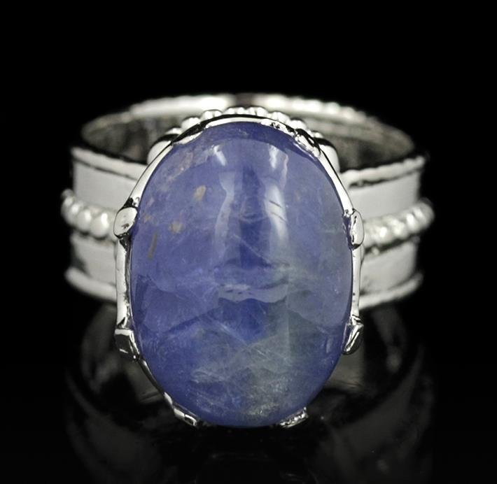 SILVER 8.55ct Tanzanite Ring: One electronically tested 925 silver ladies cast tanzanite solitaire ring with a bright polish finish. The featured tanzanite is set within a stylized under gallery supported by rope detailed shoulder