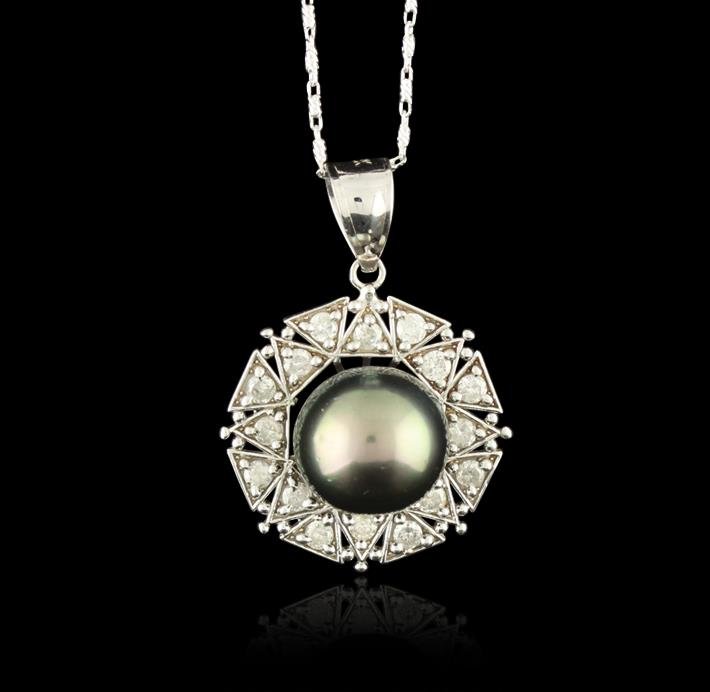 14KT White Gold Pearl and Diamond Pendant with Chain: 14KT White Gold pendant on a 14 karat white gold link chain. The pendant is mounted with: 1 genuine Tahitian Pearl and 16 genuine round full cut diamonds weighing 0.55 carats. This item weighs 6.7 gra