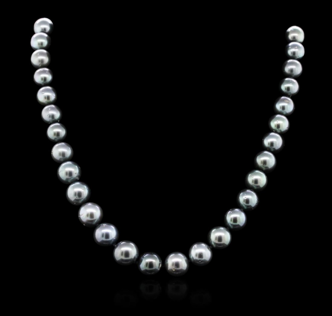 14KT White Gold Pearl Necklace: One graduated, single strand Cultured Tahitian Pearl necklace. The strand has each pearl individually hand knotted and measures 17.75 inches in length. The necklace is finished with a scalloped 14KT w