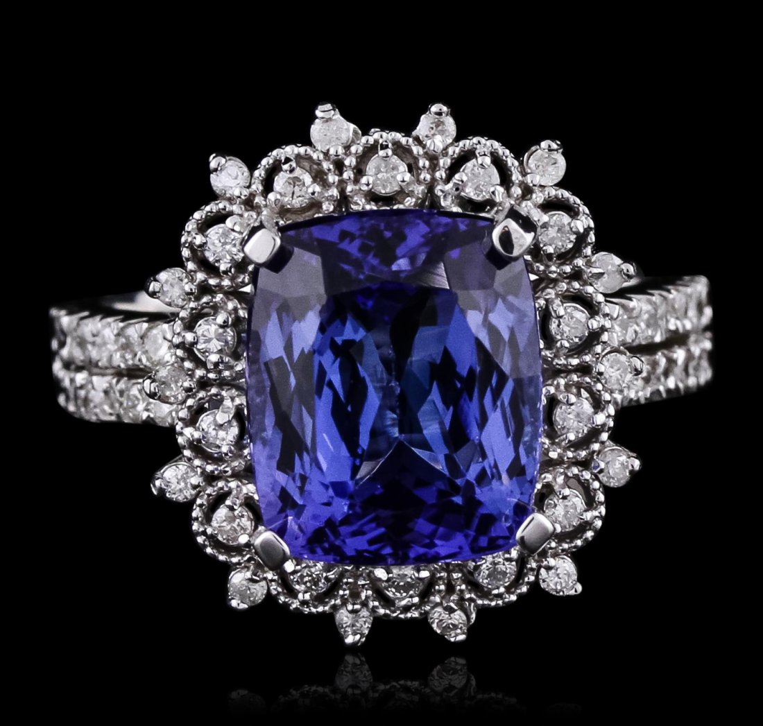 14KT White Gold 4.89ct Tanzanite and Diamond Ring: One electronically tested 14KT white gold ladies cast tanzanite and diamond ring with a bright and milgrain finish. Condition is new, good workmanship. The featured tanzanite is set within a diamond l