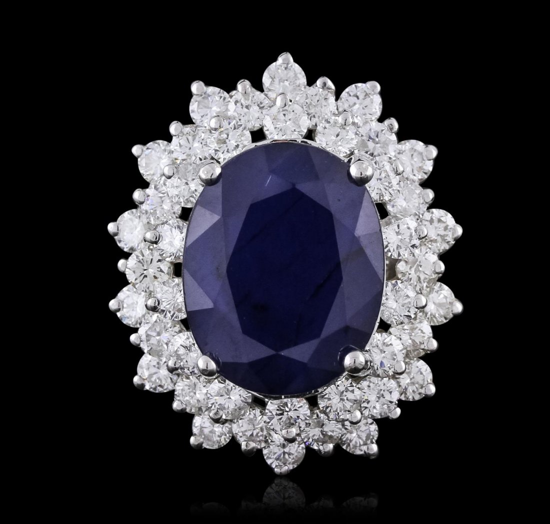 14KT White Gold 10.38ct Sapphire and Diamond Ring: One electronically tested 14KT white gold ladies combination cast & assembled ring with a bright polish finish. Condition is new. Identified with markings of "K14". Containing: One prong set oval modi