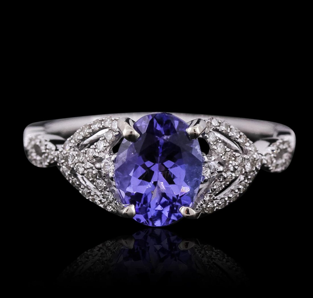 14KT White Gold 1.54ct Tanzanite and Diamond Ring: One electronically tested 14KT white gold ladies cast tanzanite and diamond ring with a bright polish finish. Condition is new, good workmanship. The featured tanzanite is supported by diamond set flo