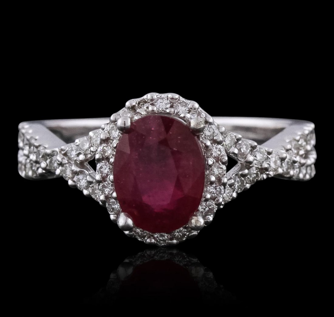 14KT White Gold 1.49ct Ruby and Diamond Ring: One electronically tested 14KT white gold Ladies cast ring with a bright polish finish. Condition is new. Identified with markings of "14K". Containing: One prong set oval modified brilliant cut natur