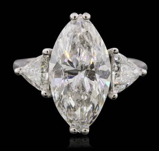 18KT White Gold 7.07ctw Diamond Ring: One white gold ring, stamped "18K" containing the center diamond described in detail below. Ring also contains 2 triangular brilliant cut diamonds that are E-F color, SI2-SI3 clarity and total weight