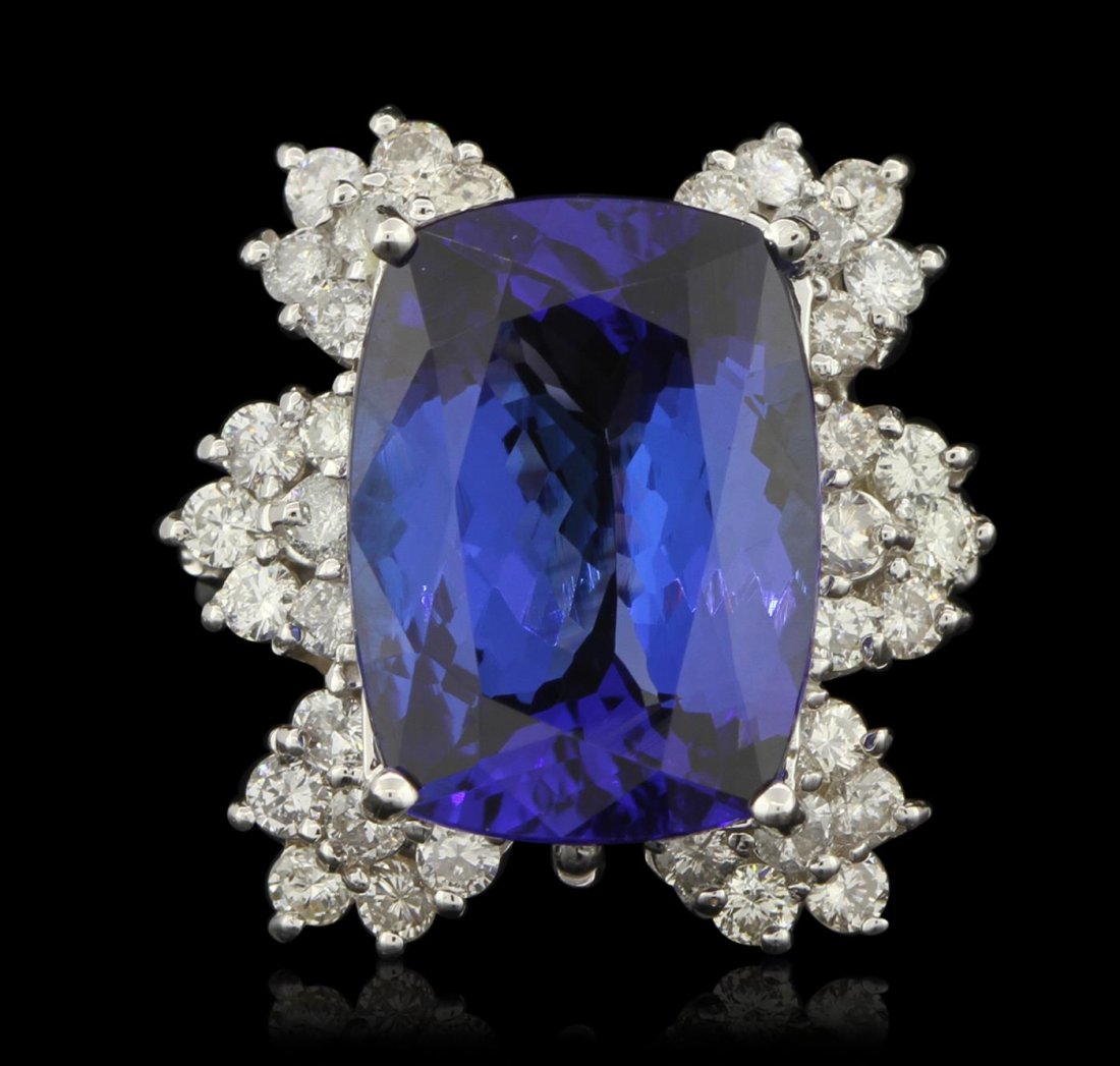 14KT White Gold 11.35ct GIA Cert Tanzanite and Diamond: One electronically tested 14KT white gold ladies cast tanzanite and diamond ring with a bright polish finish. Condition is new, good workmanship. The featured tanzanite is set within a stylized floral