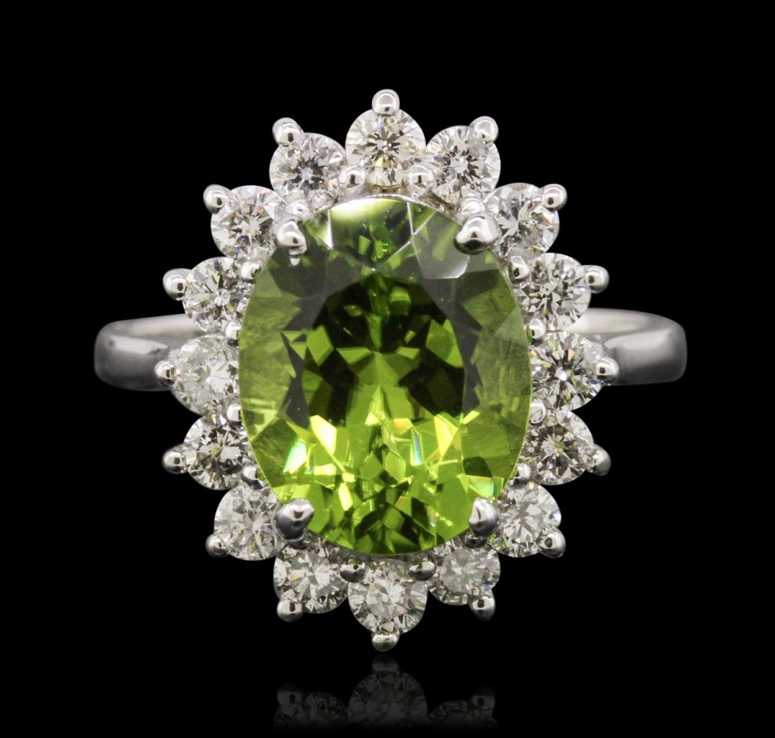 14KT White Gold 4.14ct Peridot and Diamond Ring: One electronically tested 14KT white gold ladies combination cast & assembled ring with a bright polish finish. Identified with markings of "K14". Condition is new. Containing: One prong set oval modi